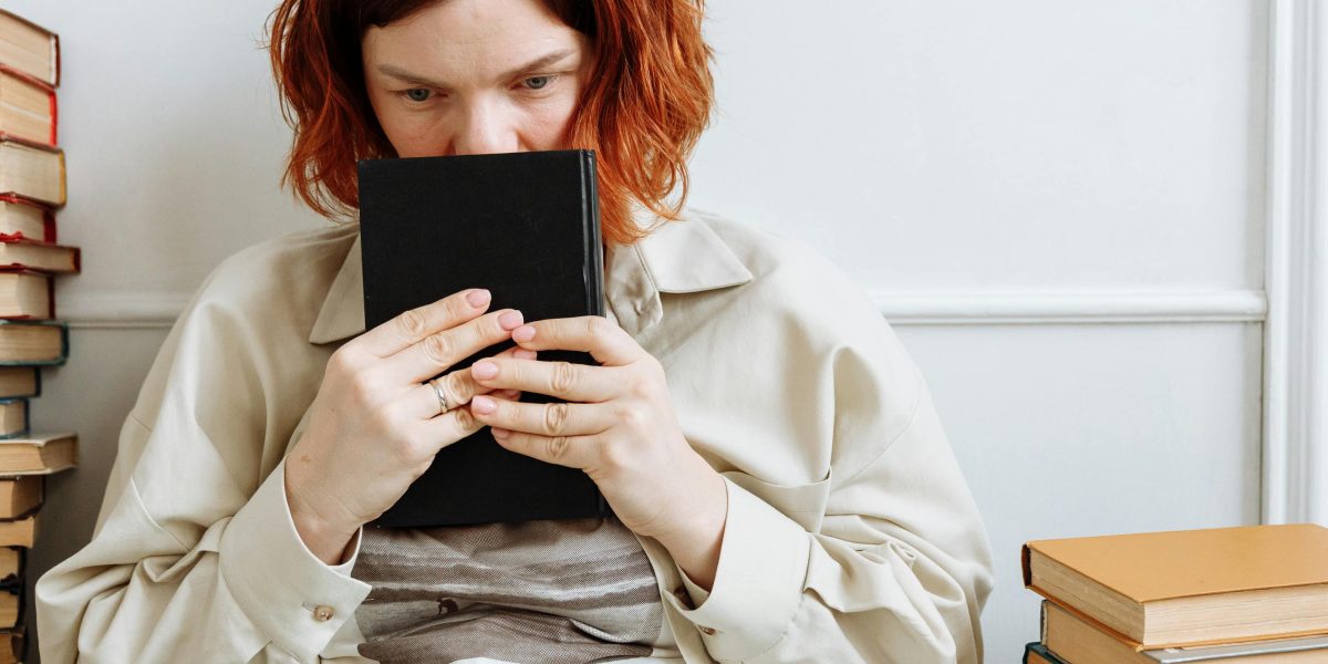 A person engrossed in reading a book, enjoying the narrative in a peaceful setting.