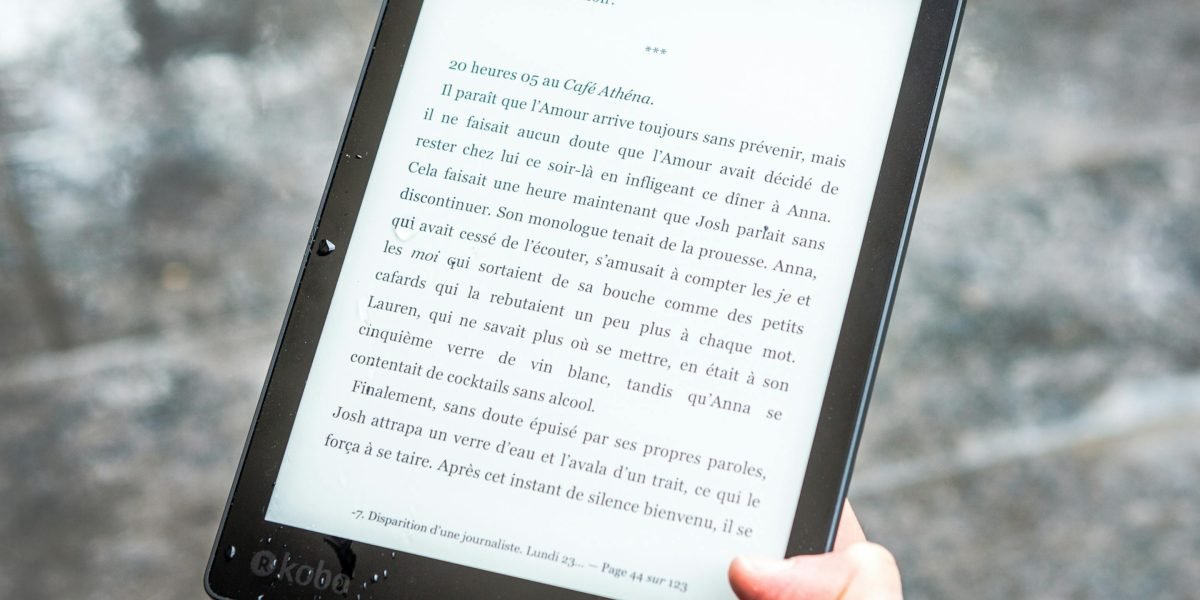 A person comfortably engrossed in reading on an e-reader or tablet, illustrating the ease and accessibility of digital book platforms.