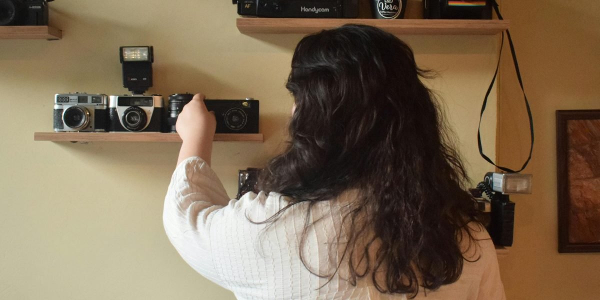 A person proudly showcasing their book collection, embodying the satisfaction of building a valuable library.