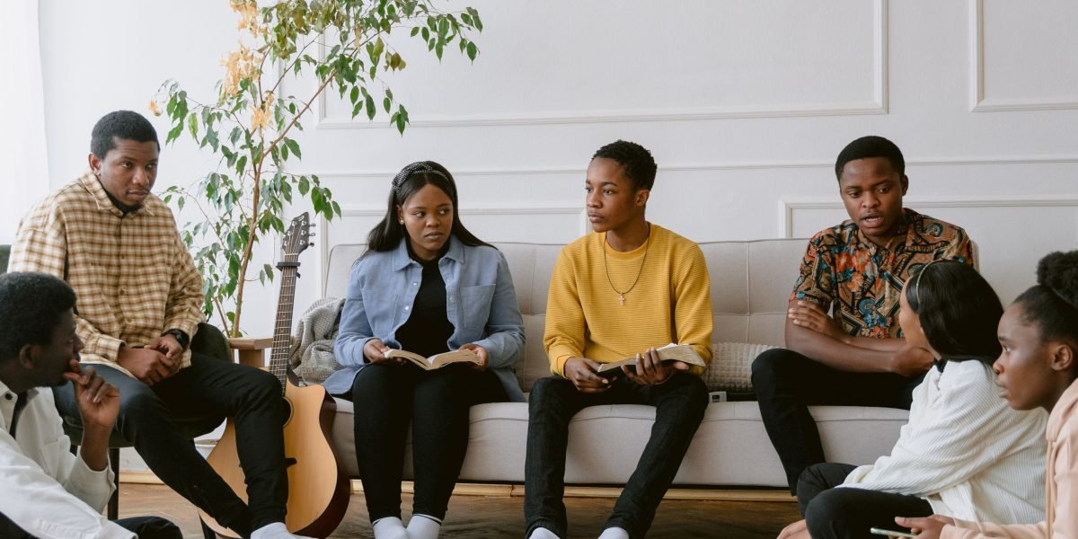 A diverse group of people actively participating in a book club meeting, discussing a novel.